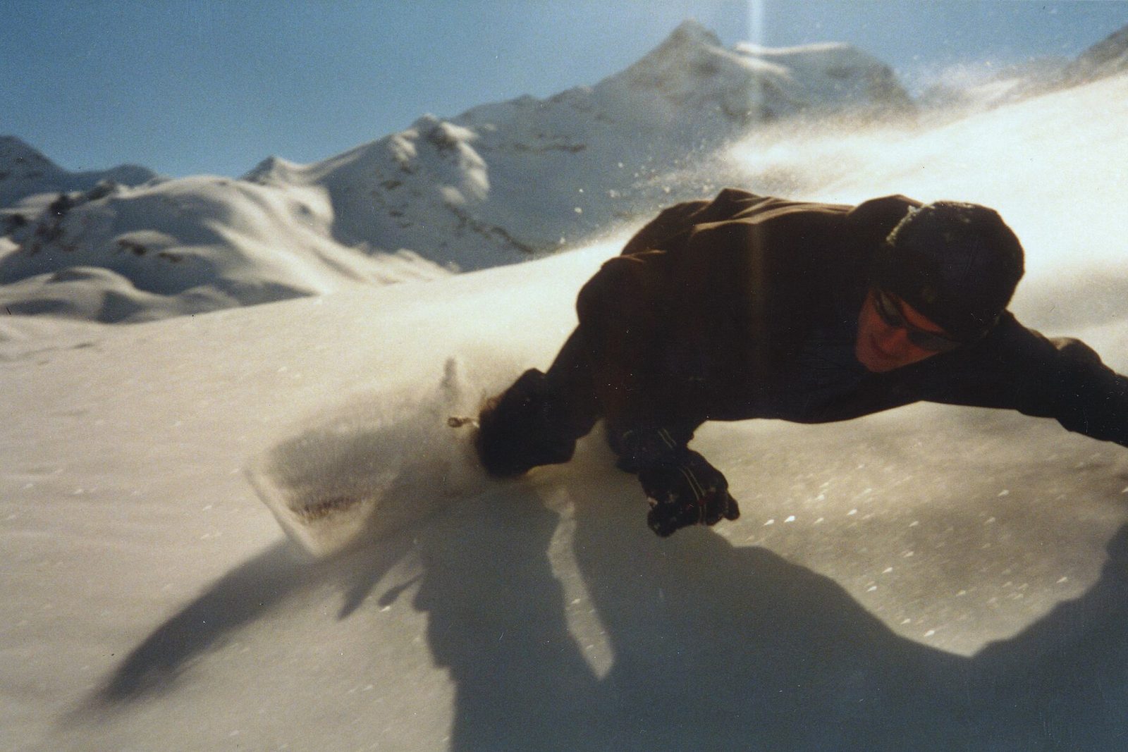Rider carving through deep loose snow