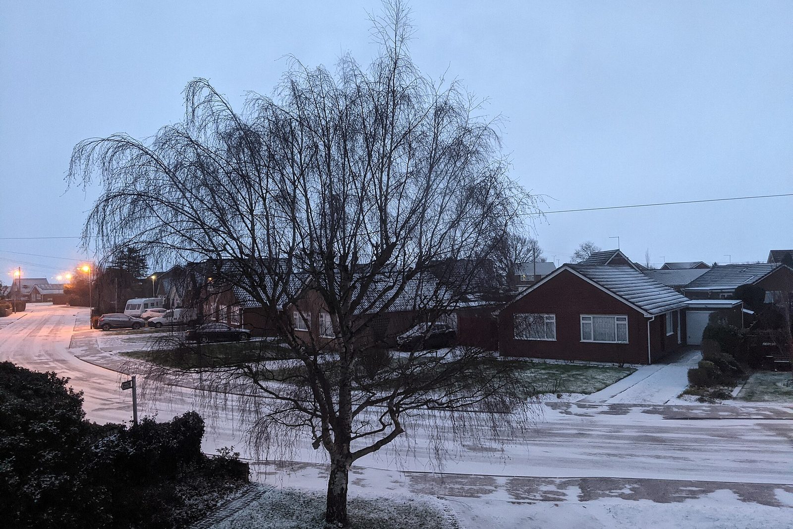 Snow-covered village street at dawn